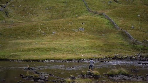 Scenery of grassy hill and stream in Scotland