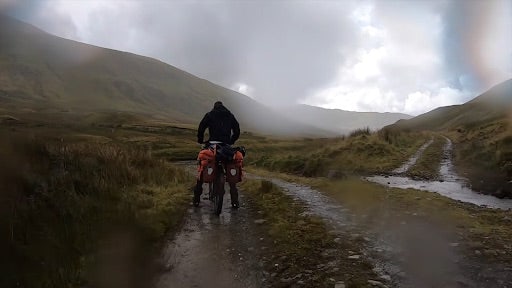 Mountain biking through water in Scotland