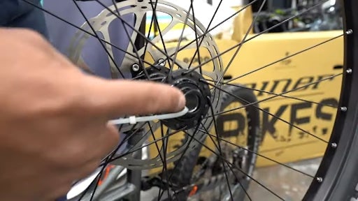 Remove packaging from around wheel, keep caps on