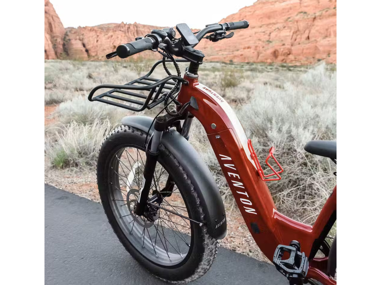 Aventon Aventure Front Rack Shown Installed on a red Aventure with Desert hills and shrubbery in background