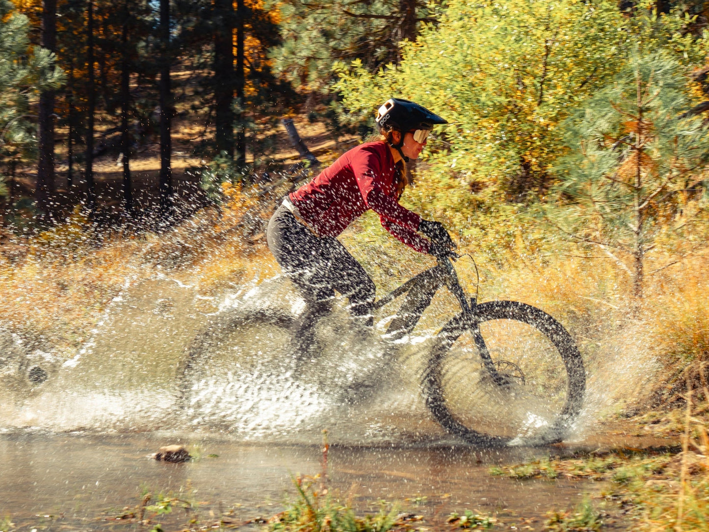Aventon Ramblas Hardtail eMTB Female riding through water