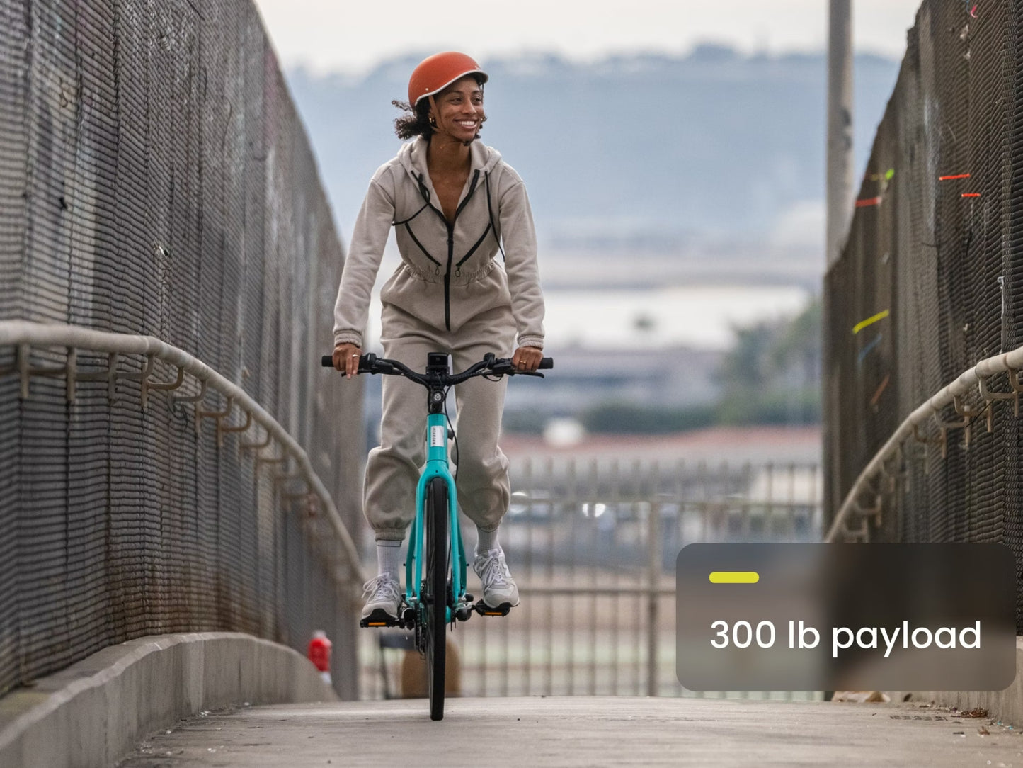 Aventon Soltera 2.5 Road /commuter Urban eBike Baja Woman riding over bridge