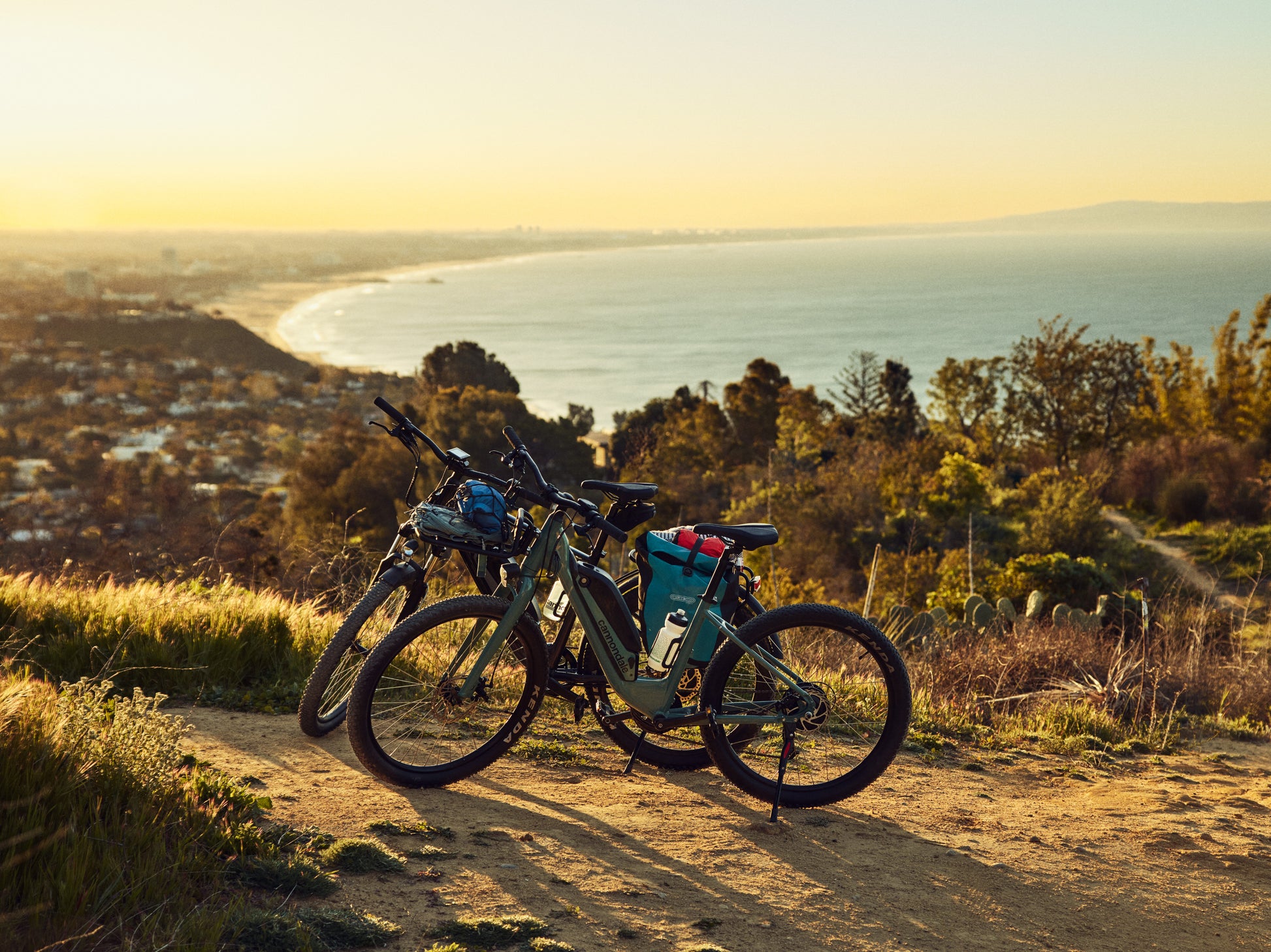Cannondale Adventure Neo Allroad Low Step-Thru Road/commuter Two bikes parked on top of a hill, overlooking the ocean