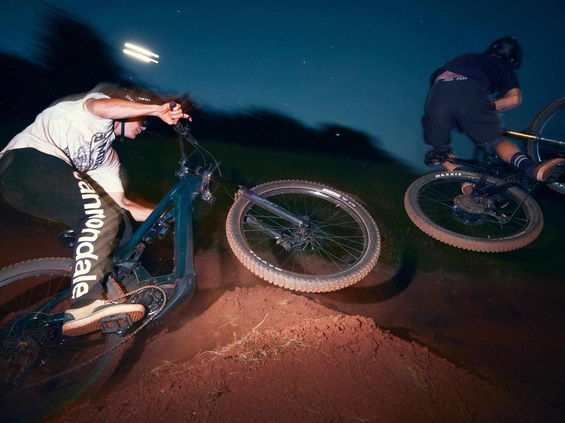 Cannondale Moterra Carbon 1 Full Suspension eMTB Two riders jumps on dirt track, night ride