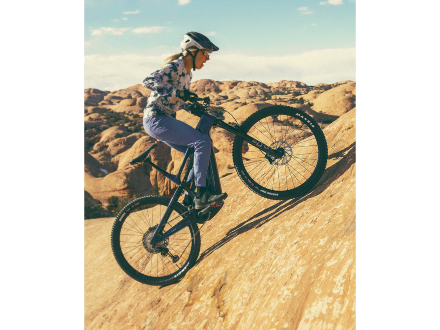 Cannondale Full Suspension eMTB Woman rider climbing Rocky hill