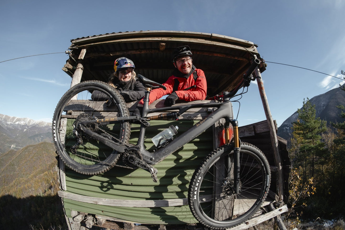 Cube AMS Hybrid One 44 C:68X Man & woman in deer hide out, up high above forest