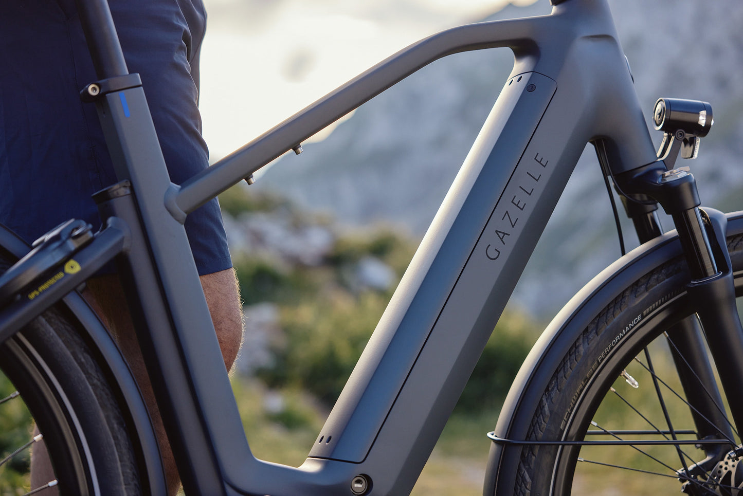 Gazelle_Eclipse_C380__High_step_Anthracite_grey_Lifestyle_bike_in_forefront_mountain_landscape_in_background_Fly_Rides_USA