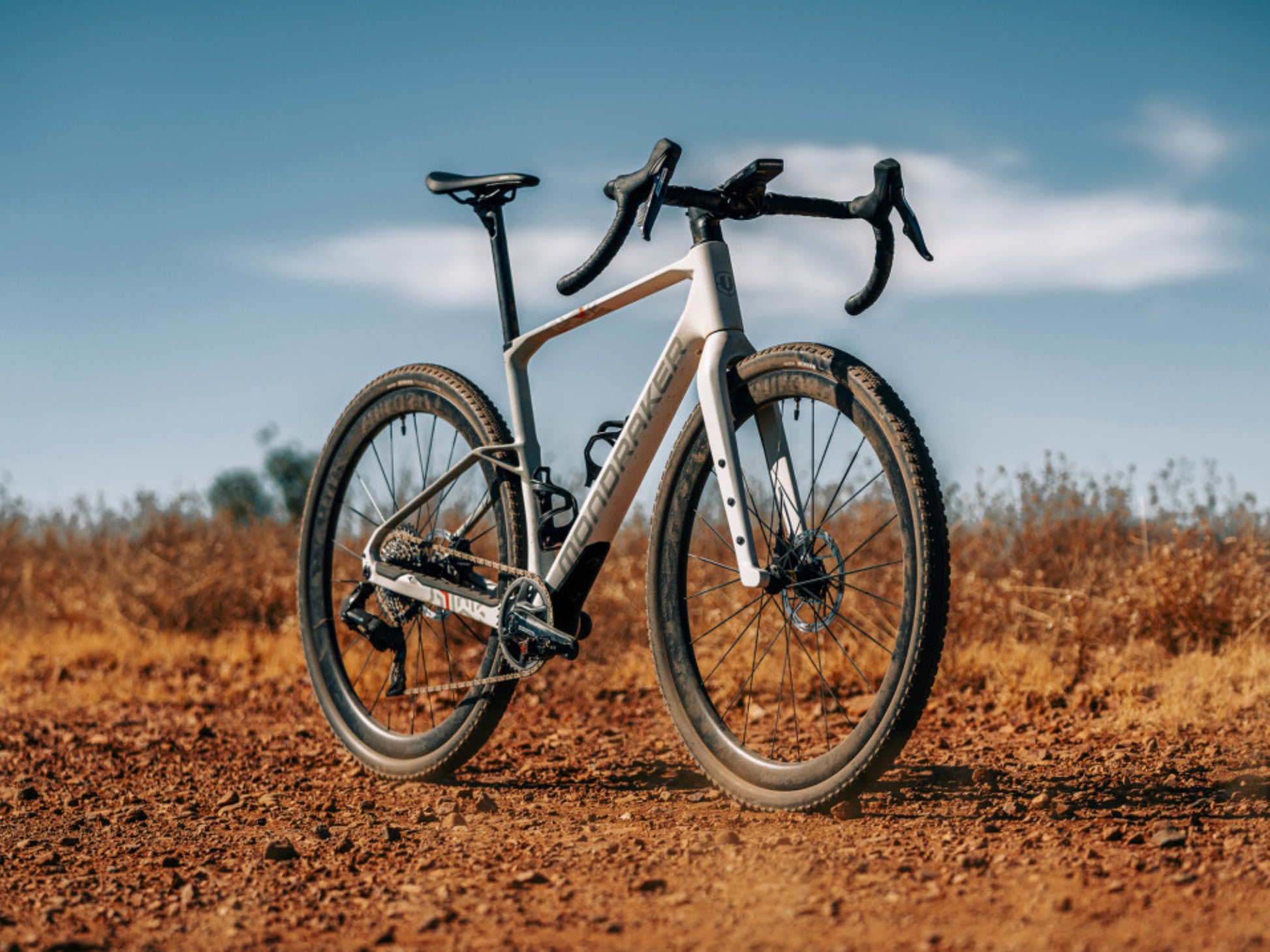 Mondraker Arid Carbon RR Gravel Road / commuter bike Bunker grey Forward facing view. Lifestyle on gravel road