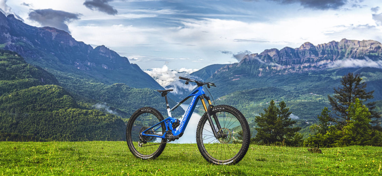 Mondraker Neat RR SL Parked on green grass with rolling green hills in the background