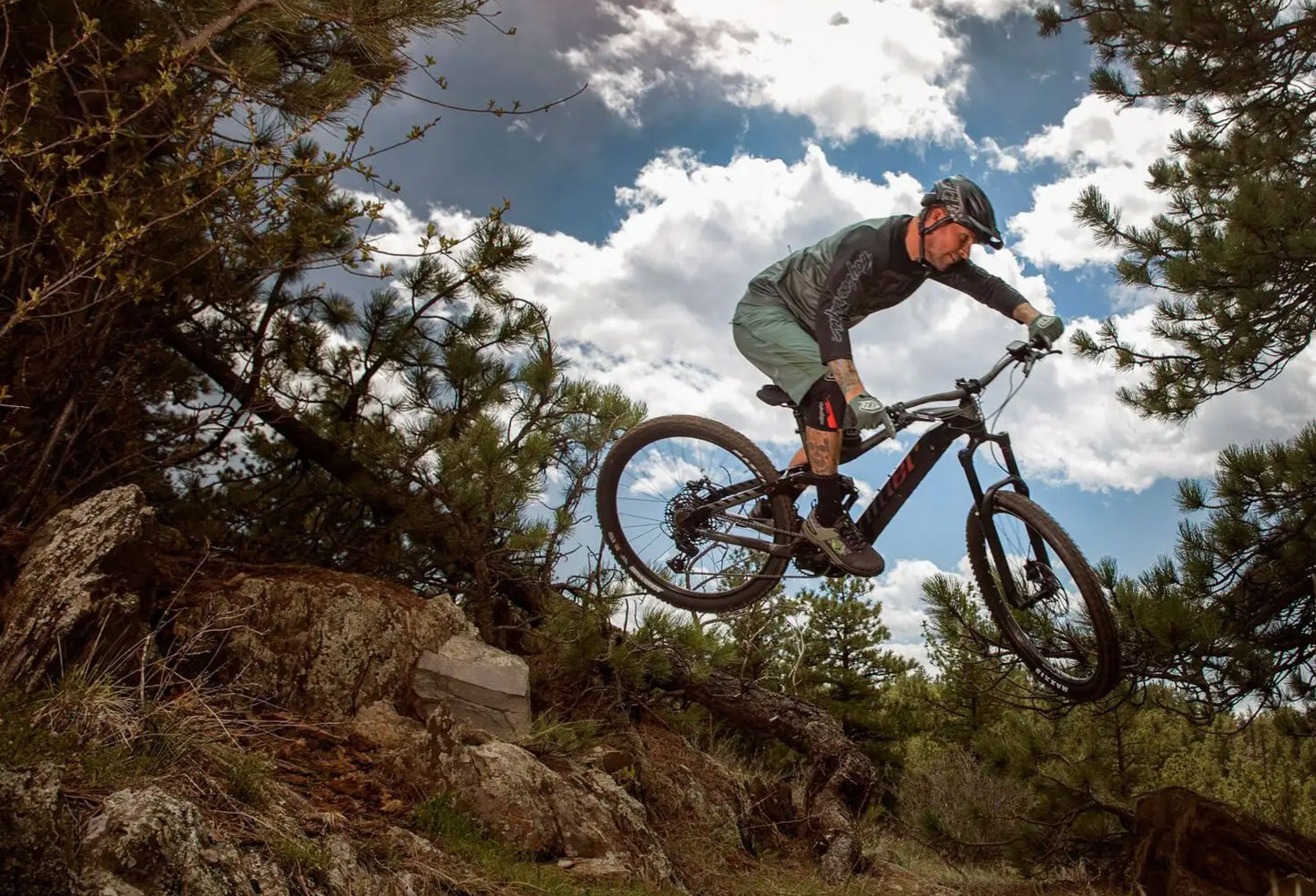 Niner Lifestyle Man Jumping rocky terrain 