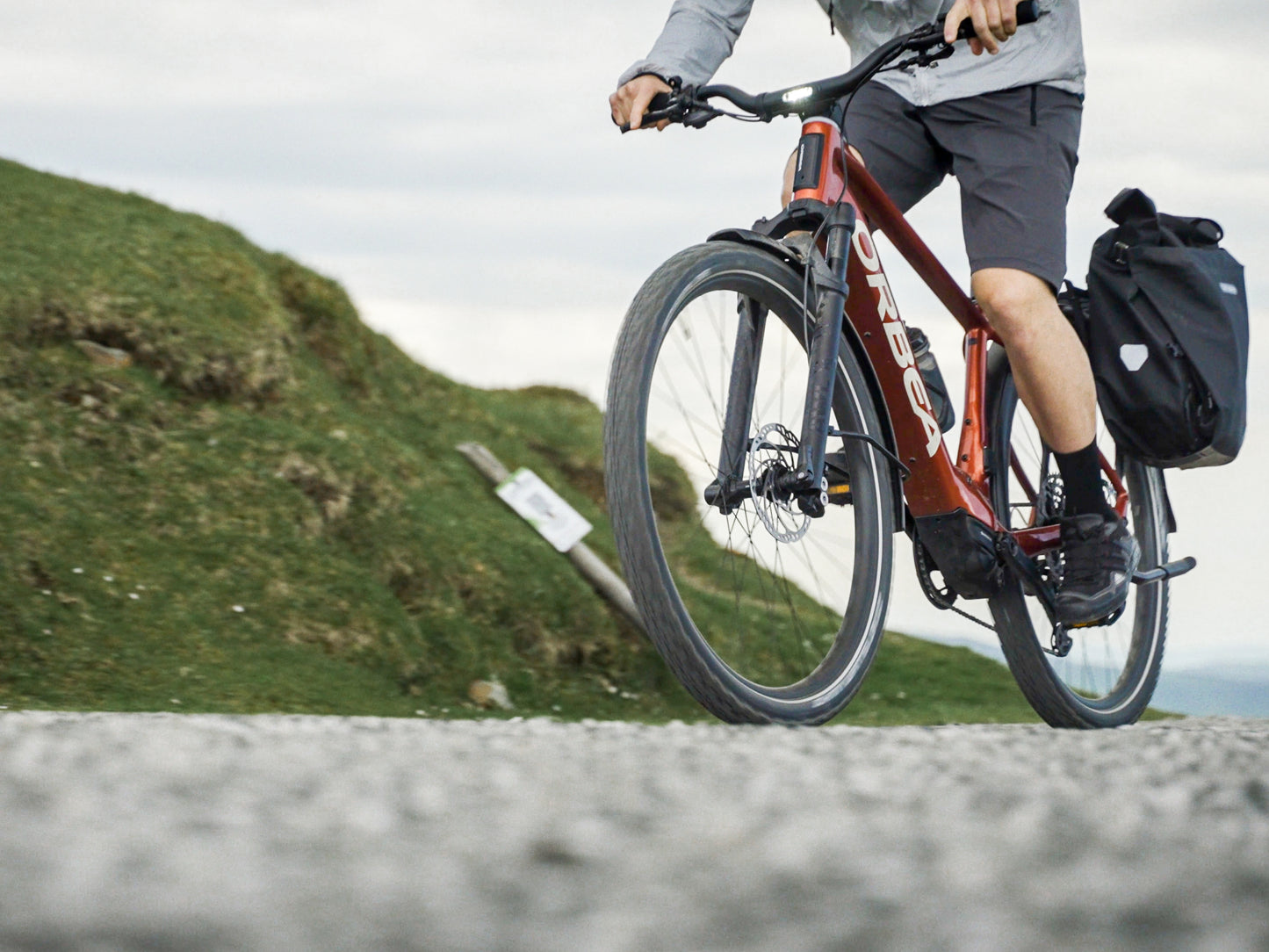 Orbea Kemen ADV 30 Mars red / white gloss Lifestyle Rider on trail with rear saddle bags