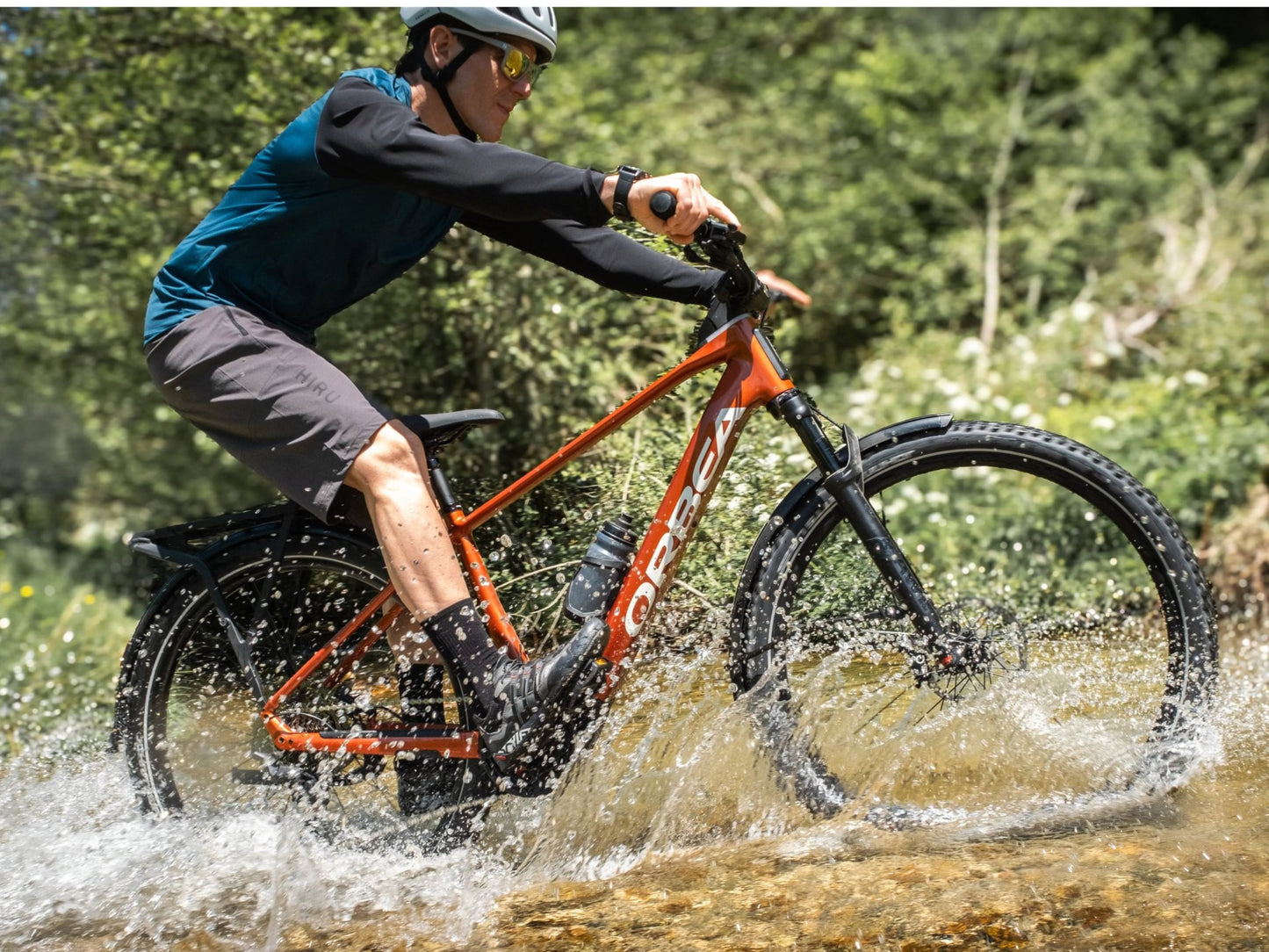 Orbea Kemen ADV 30 Mars red / white gloss Lifestyle Rider on trail splashing through water