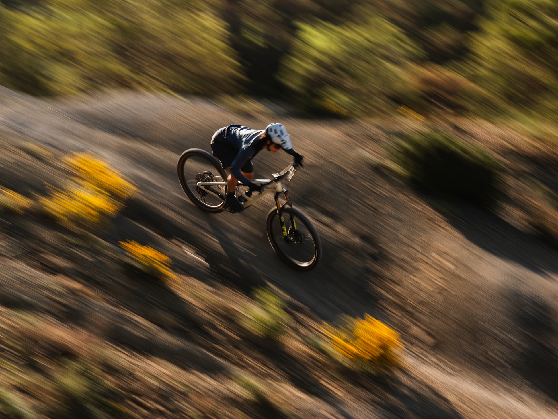 Orbea Occam SL Full Suspension Mountain bike, Lifestyle. Downhill rider on dirt path speed shot