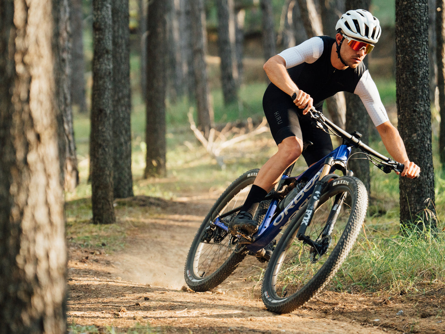 Orbea Oiz Full Suspension Mountain bike man riding on dirt single track amongst large trees