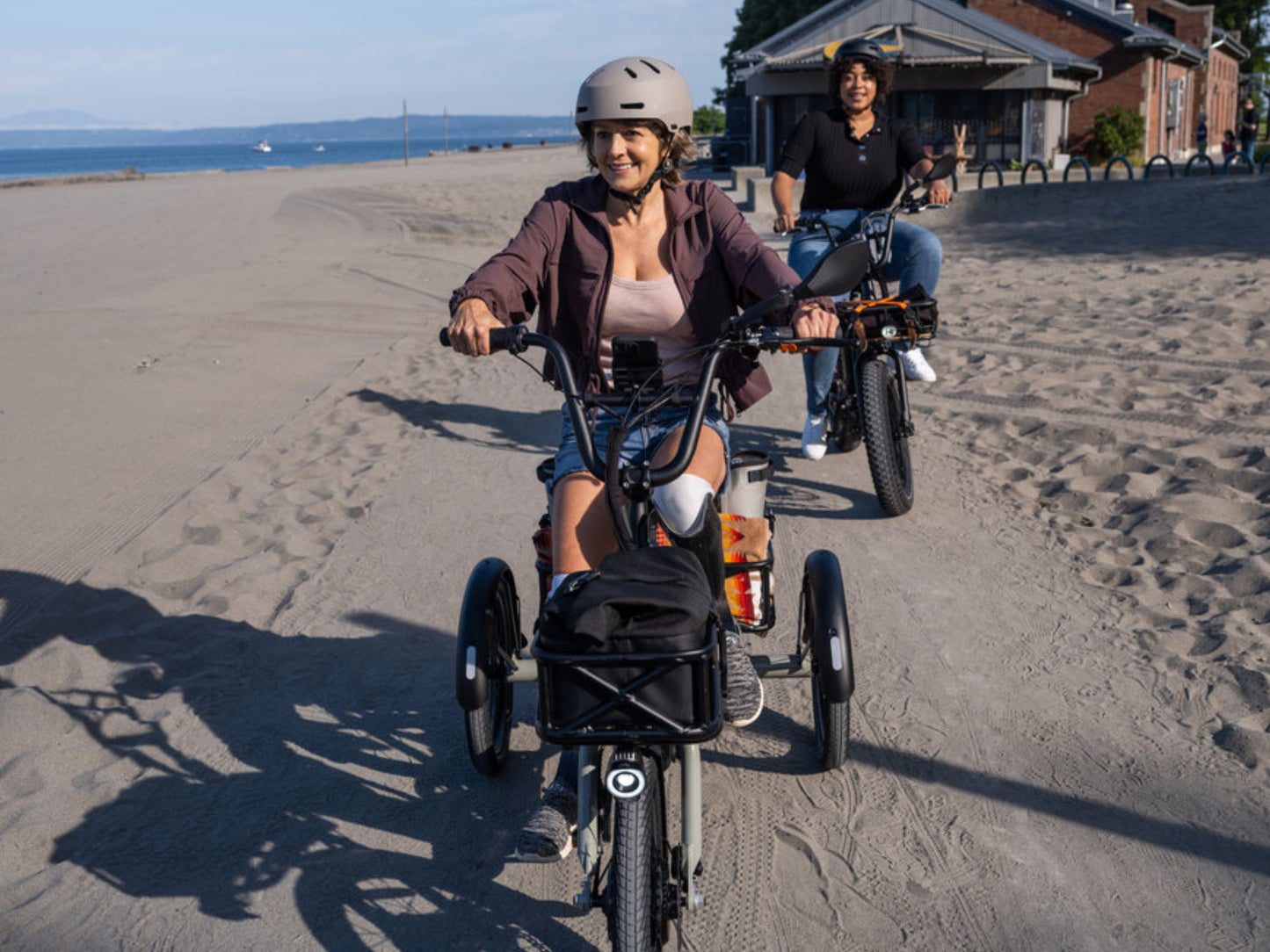 Rad Power RadTrike™ Electric Tricycle Gray Women riding on the beach