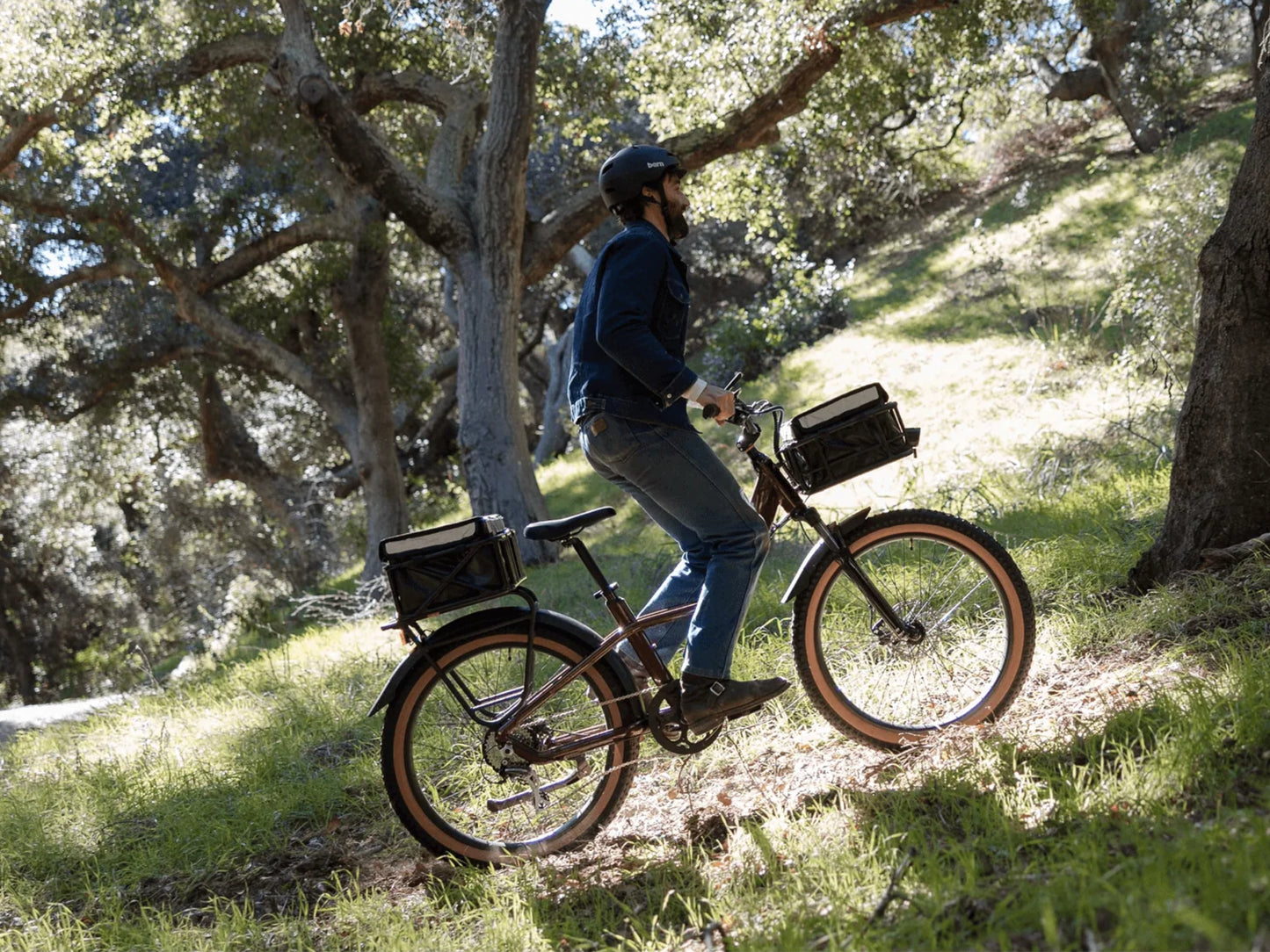 Rad Power Radster™ Trail Electric Off-Road Bike Copper red. Man climbing offroad dirt path.