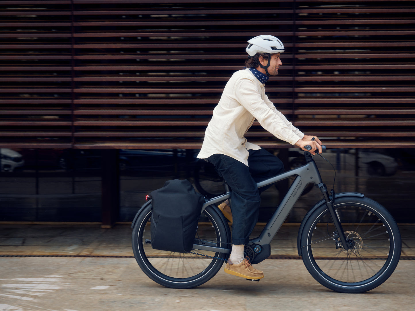 Riese & Muller Charger5 male rider commuting. Optional accessories shown