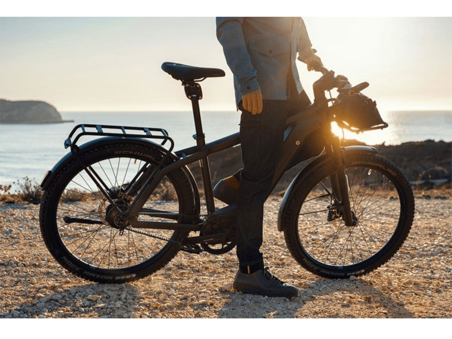 Riese and Muller Charger4 GT Rohloff emtb hardtail man parked roadside ocean in background