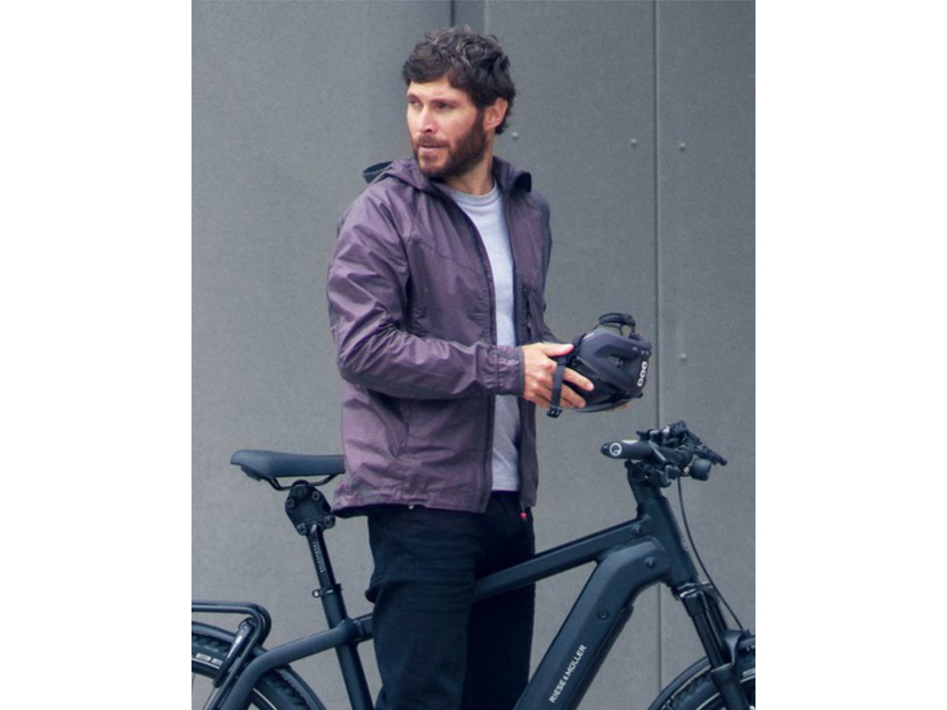 Riese and Muller Charger4 GT Touring eMTB man standing with bike