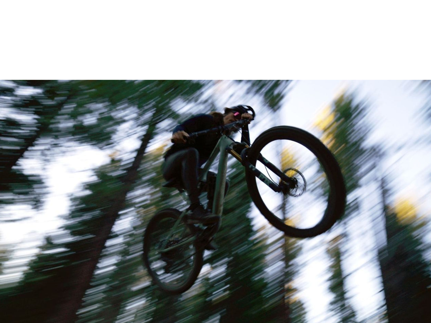 Specialized Epic 8 EVO Full suspension Mountain bike Rider getting big air amongst the trees