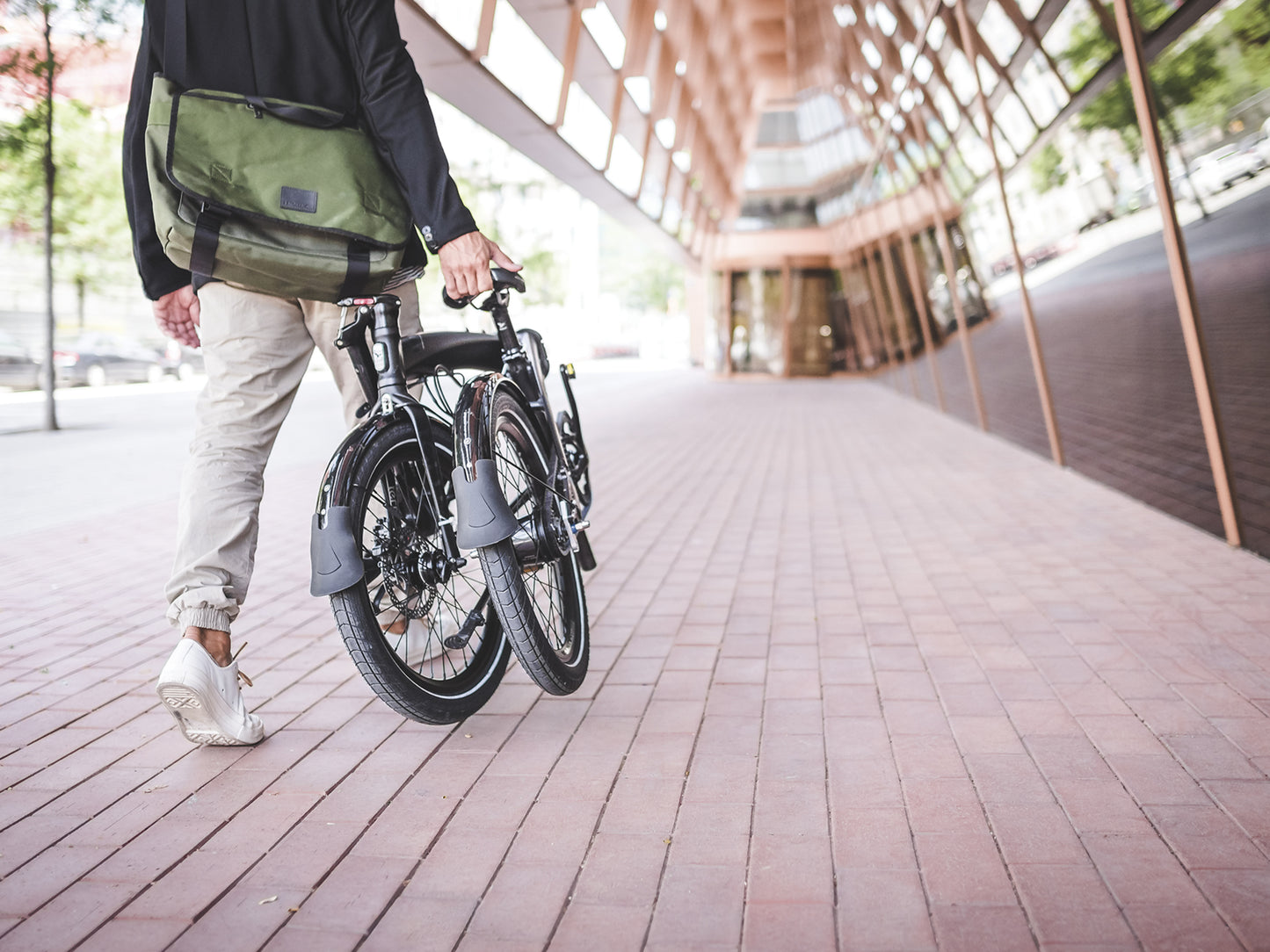 Tern Verge D9 folding bike commuter / leisure Shown folded being carried on city sidewalk