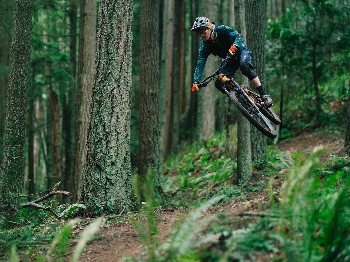 Transition Regulator SX Carbon Full suspension eMTB Rider catcing air on a forest trail