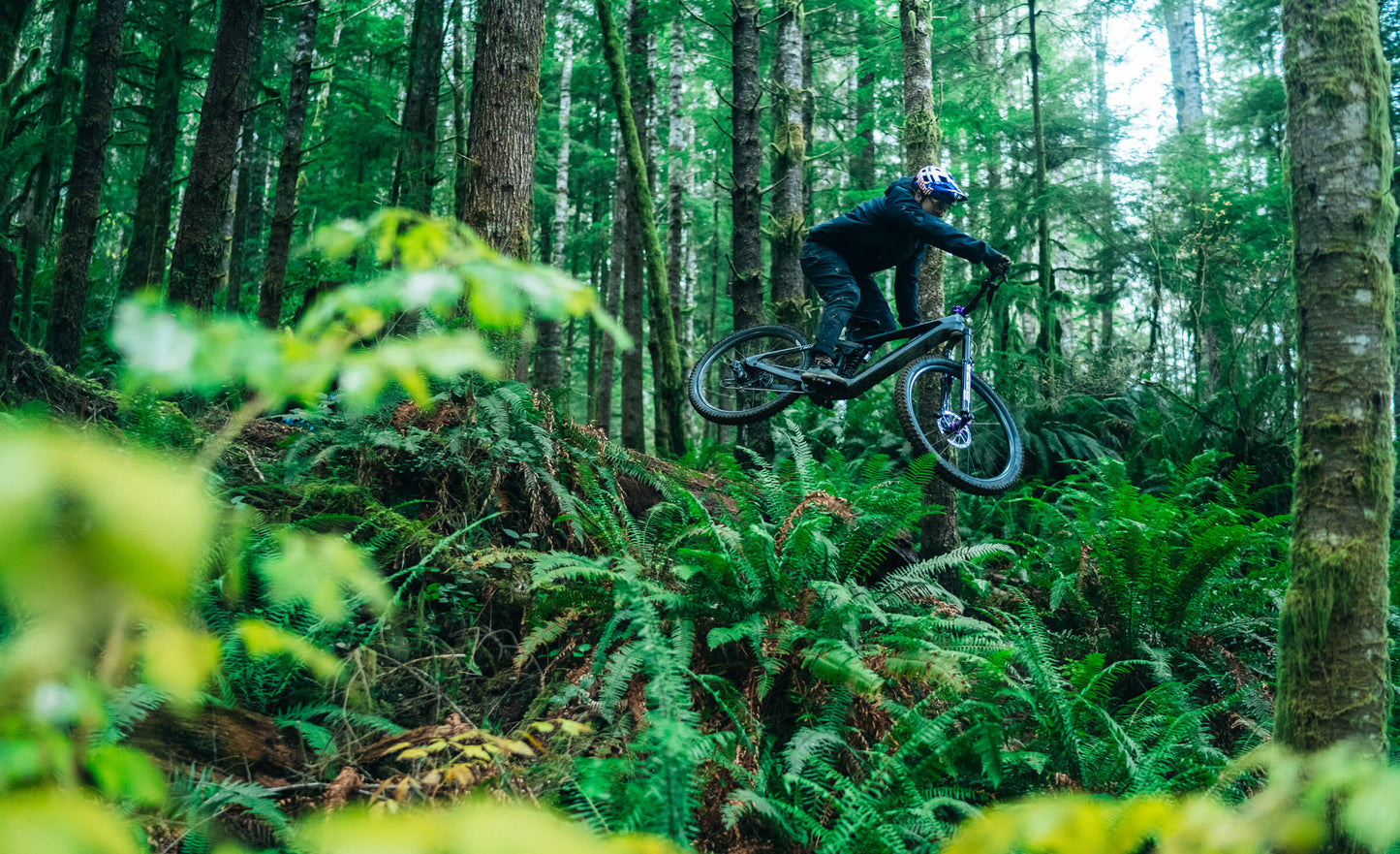 Transition Relay Guy in forest getting air, jumping