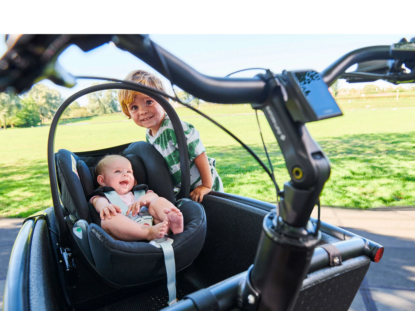 Urban Arrow Family Baby Car Seat Adapter Shown with baby in seat, installed and another child