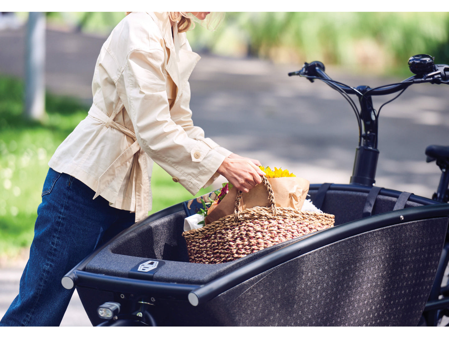 Urban Arrow Family Performance cargo electric bike lady loading groceries into cargo area