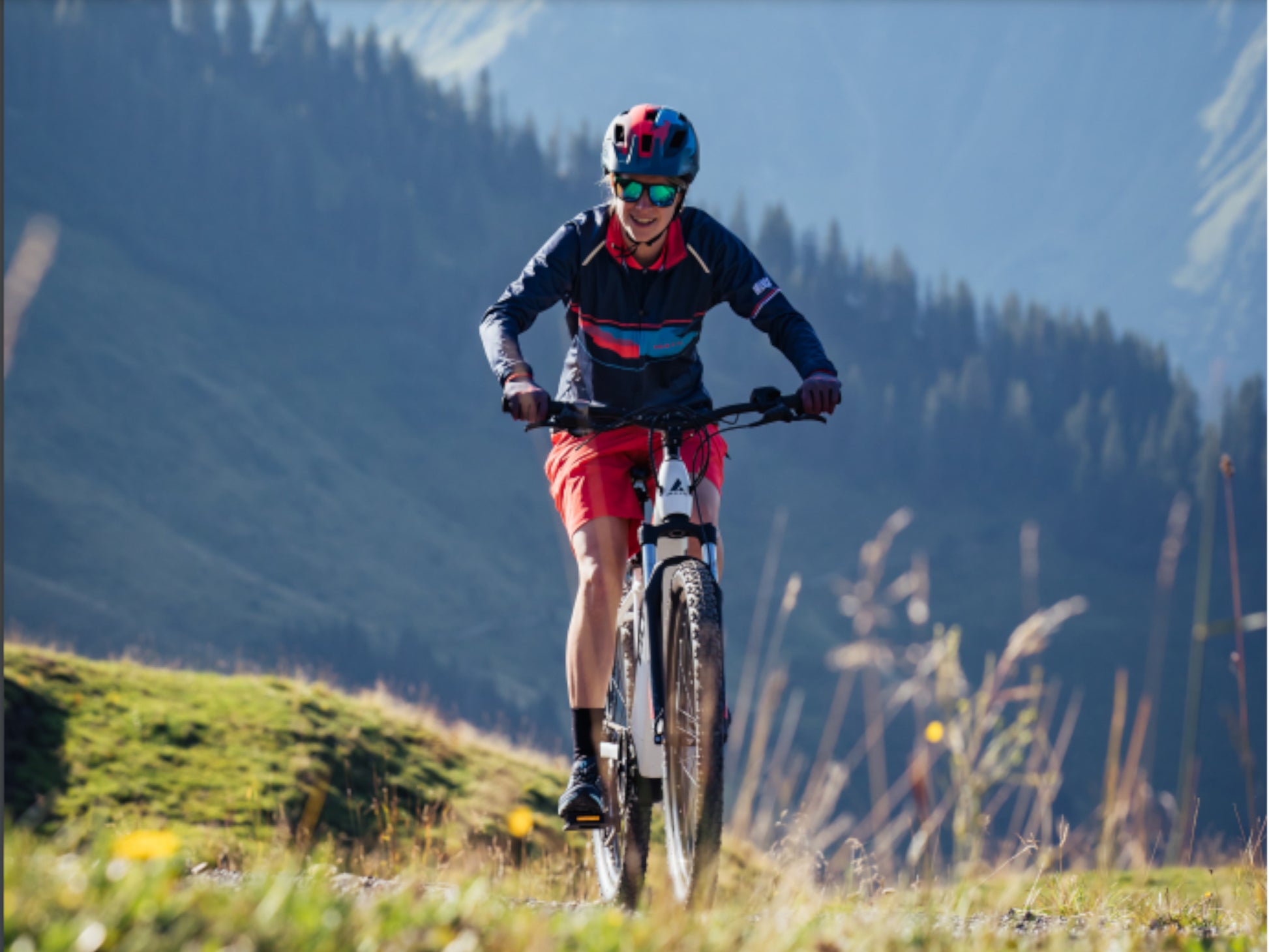 Bulls Aminga EVA TR 1 eMTB full suspension woman riding uphill singletrack on Fly Rides.jpg