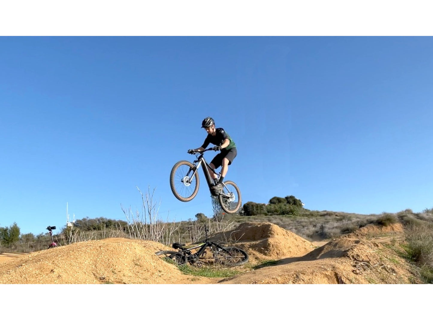 Bulls Copperhead EVO AM 3 750 eMTB full suspension man catching air on jump rolling hills