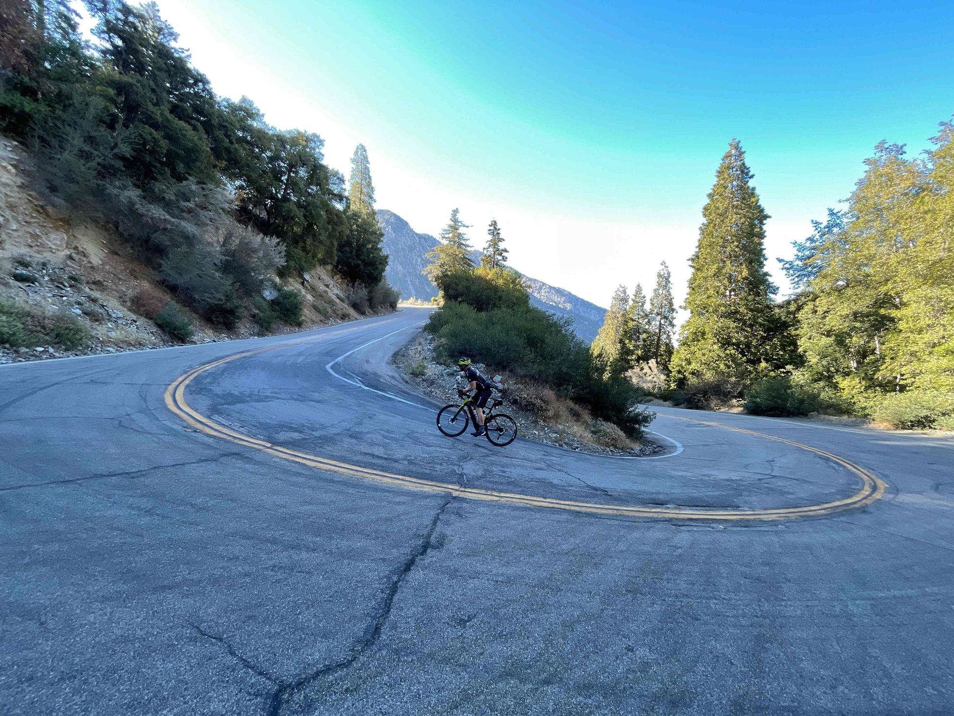 Bulls Desert Falcon EVO e road bike Chrome red black rider climbing steep mountain road side