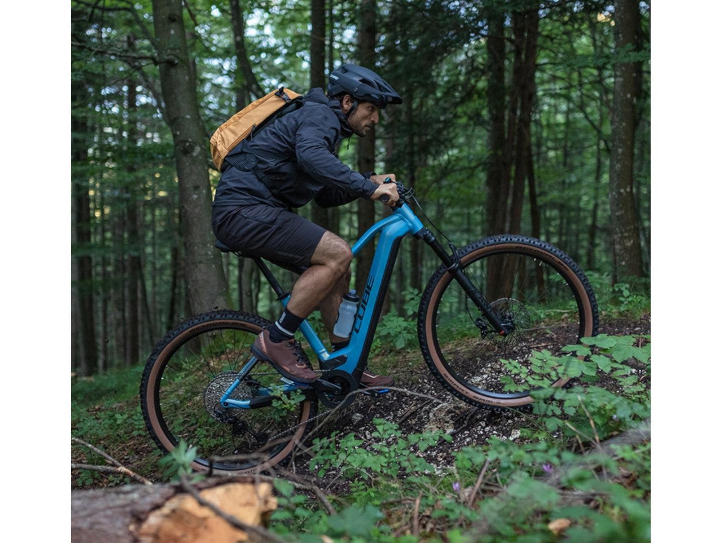 Cube Reaction Hybrid Race 625 eMTB hardtail man riding uphill on forest singletrack trail