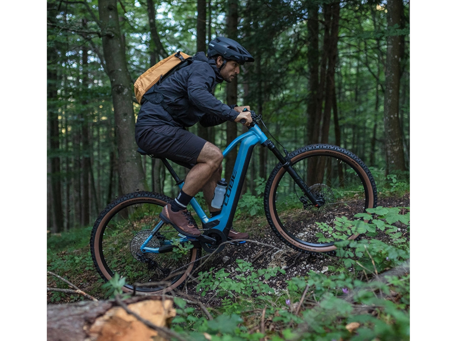 Cube Reaction Hybrid SLT 750 eMTB hardtail man riding up single track forest trail