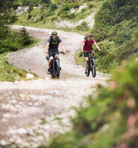 Cube Stereo Hybrid 140 HPC Race 625 electric mountain bike riders on fireroad on Fly Rides