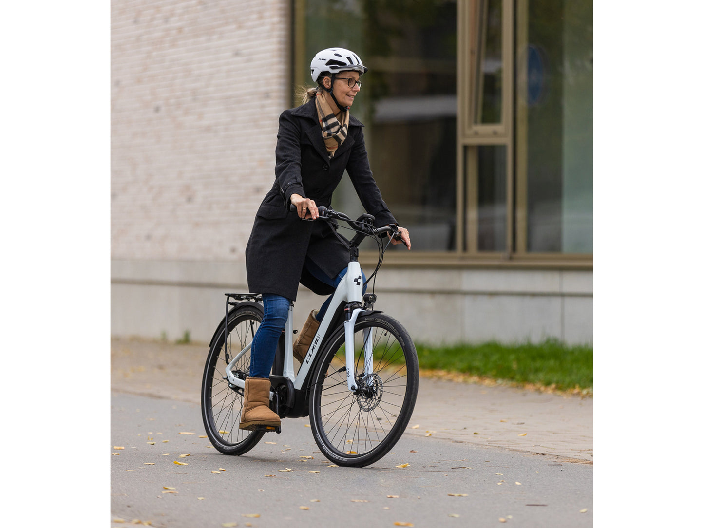 Cube Supreme Hybrid One 500 eMTB hardtail woman riding on city street