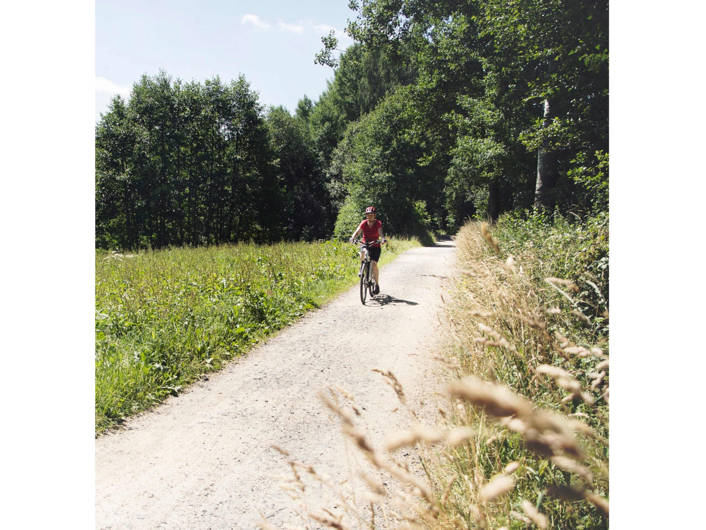 Cube Supreme Sport Hybrid One 500 eMTB hardtail woman riding on country road