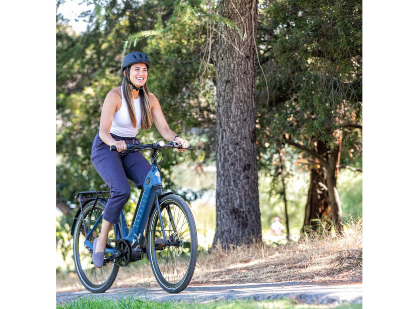 Gazelle Ultimate C380 Low Step eMTB hard tail woman riding up hill on bike path