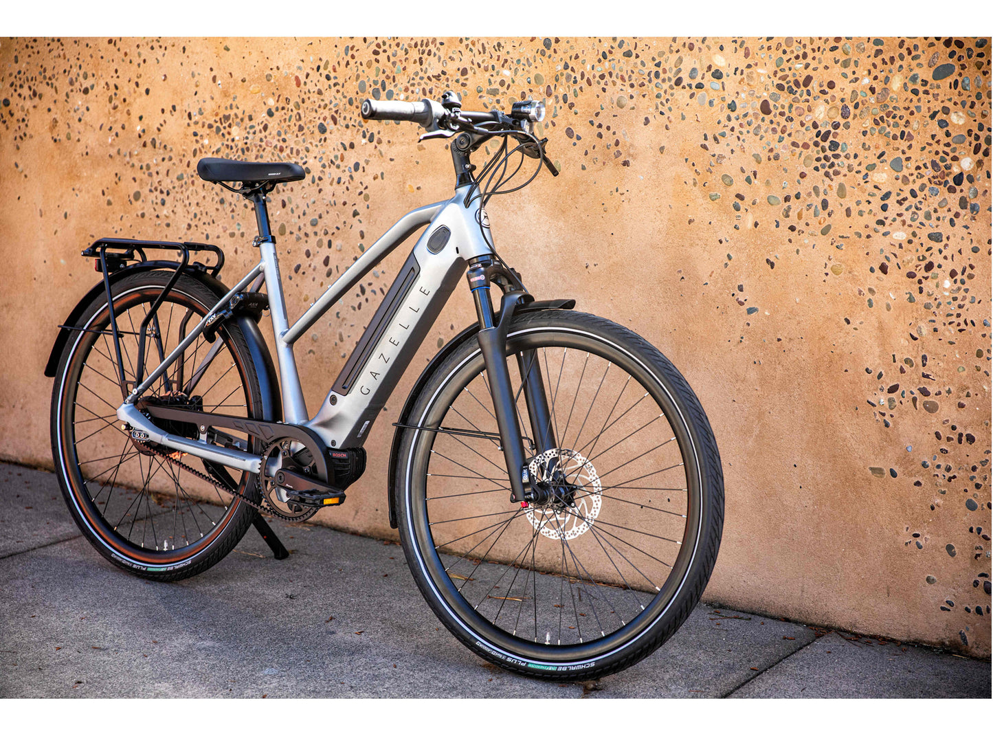 Gazelle Ultimate C380+ Mid step industry grey matte action photo of bike parked