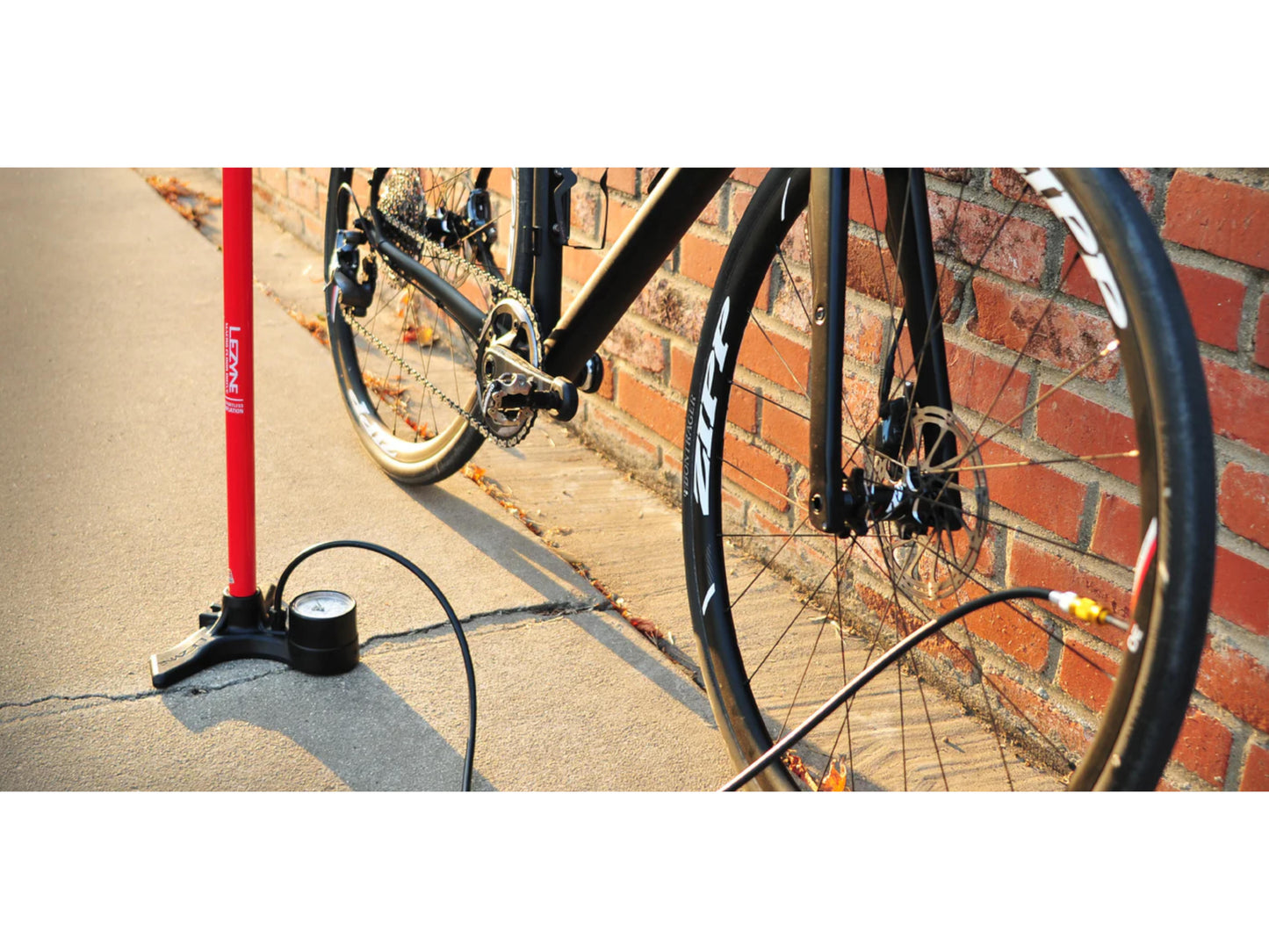 Lezyne Floor Pump Macro floor drive 2.5 Dual Valve inflating road bike tire brick wall background