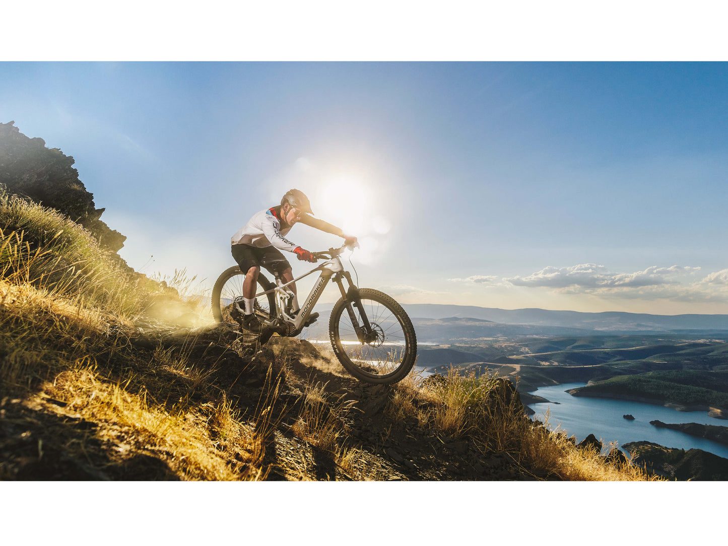 Mondraker Crafty Carbon RR eMTB full suspension carbon orange man riding down technical single track