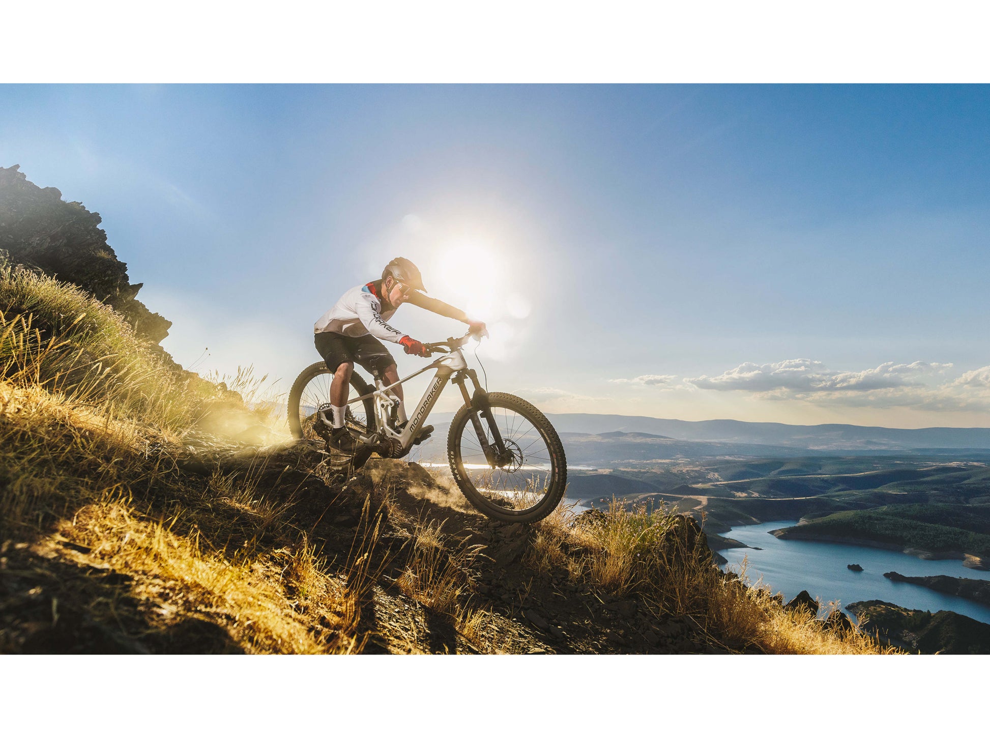 Mondraker Crafty Carbon RR eMTB full suspension carbon orange man riding down technical single track