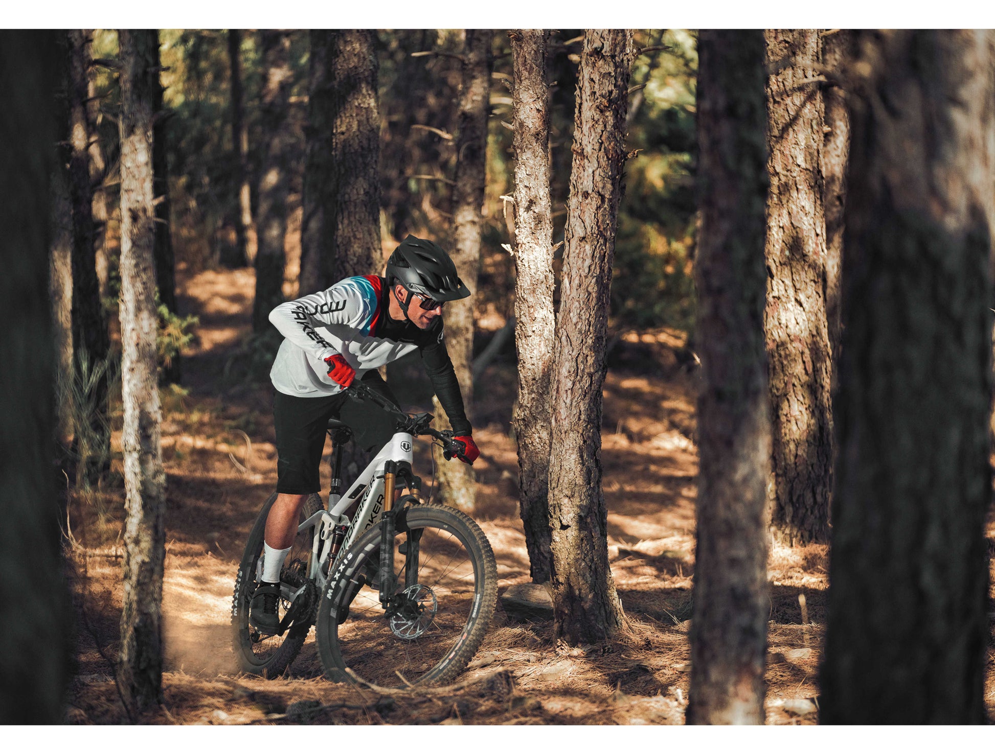 Mondraker Crafty Carbon RR eMTB full suspension carbon orange man riding forest trail