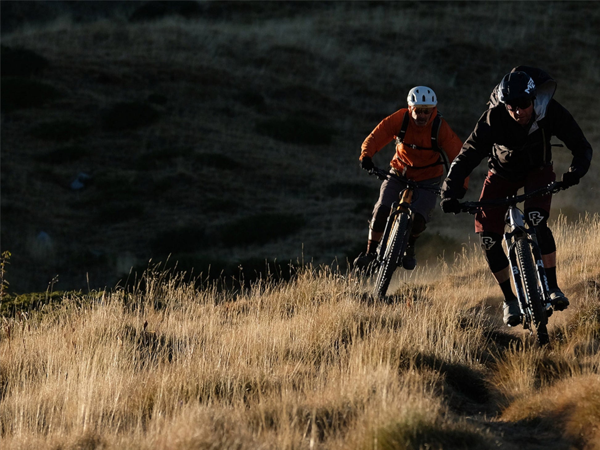 Two guys riding singletrack on Orbea Rise SL H30 e-mountain bikes