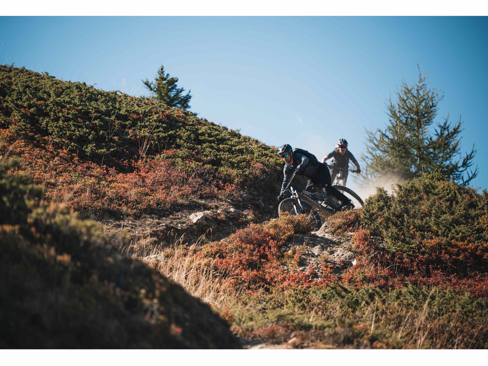 Orbea Rise M-LTD eMTB full suspension two people riding down mountain single track