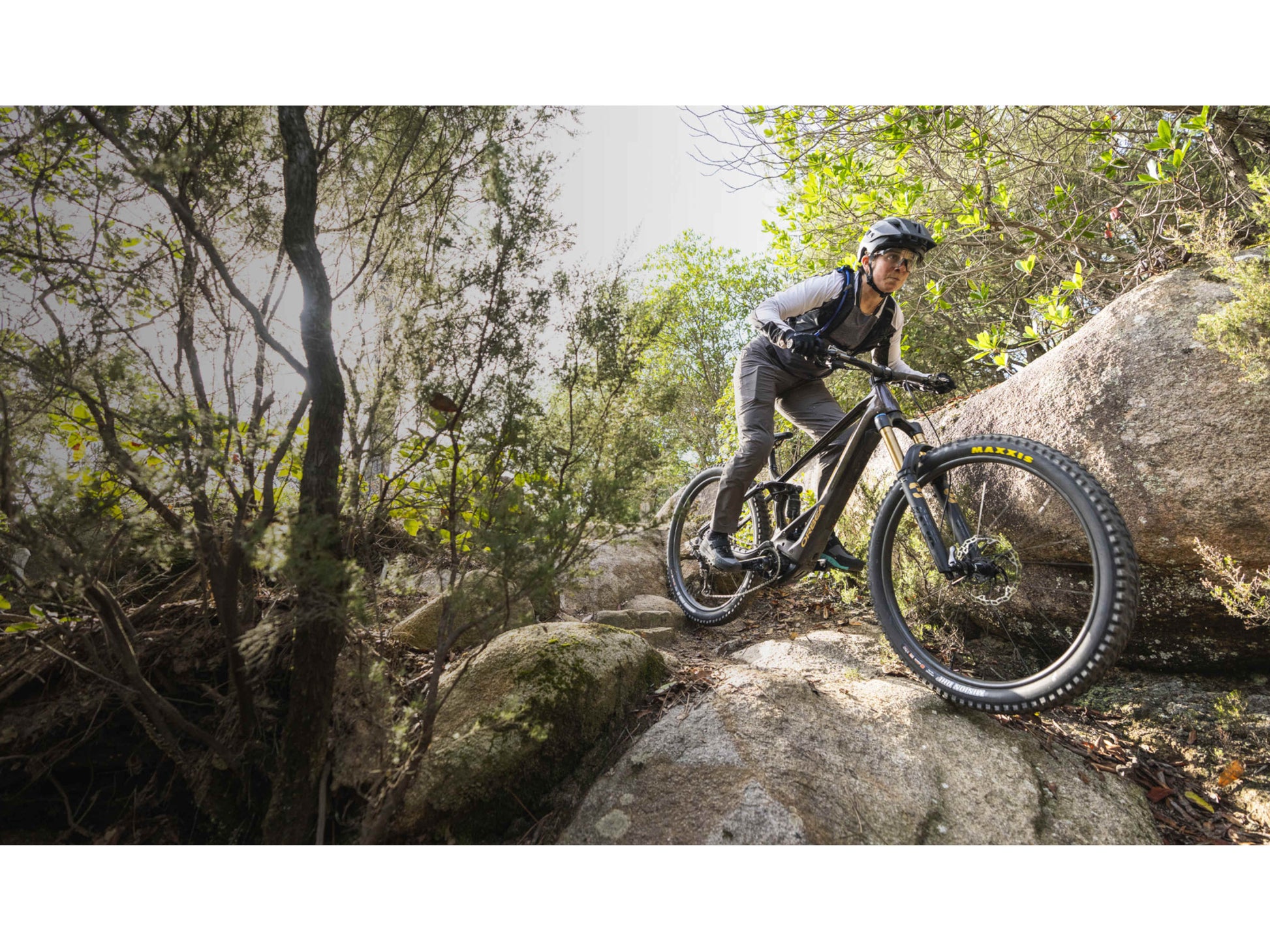 Orbea Wild H30 eMTB full suspension rider riding downhill technical boulder trail