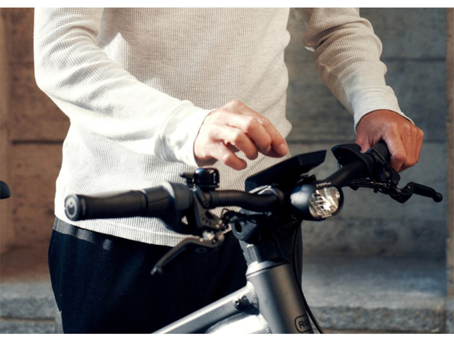 Riese and Muller Delite GT Vario HS eMTB man adjusting display on bikes cockpit