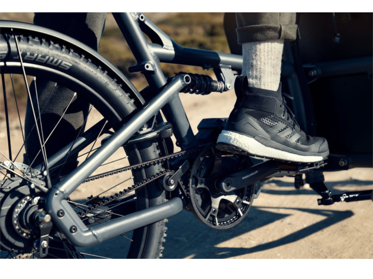 Riese and Muller Load 60 Touring HS eMTB full suspension closeup crankset mans foot on pedal