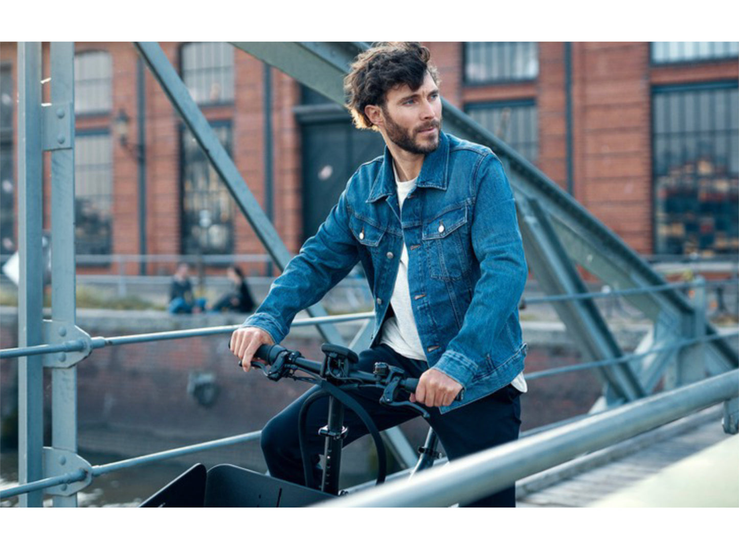 Riese and Muller Load 75 Rohloff eMTB full suspension man standing on bridge sight seeing