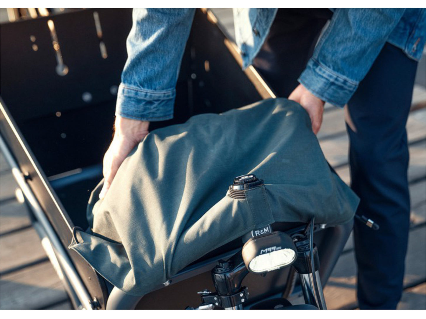 Riese and Muller Load 75 Touring HS eMTB full suspension man pulling tarp over cargo area